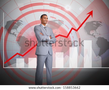 Attractive businessman standing in front of graphics in a grey suit