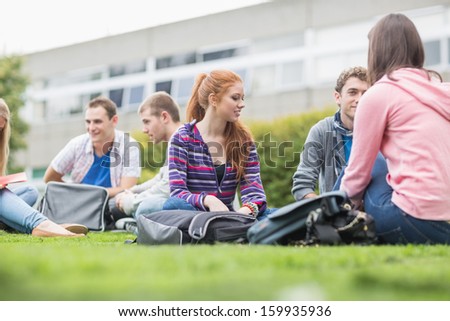 Group of young college students sitting in the park