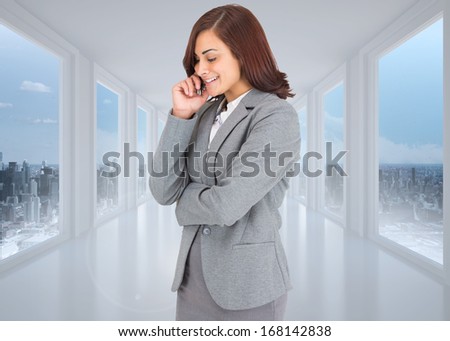 Happy businesswoman against bright white hall with windows
