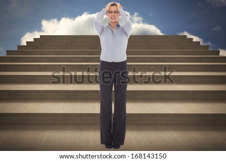 Desperate businesswoman against steps against blue sky