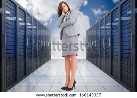 Focused businesswoman against server hallway in the sky