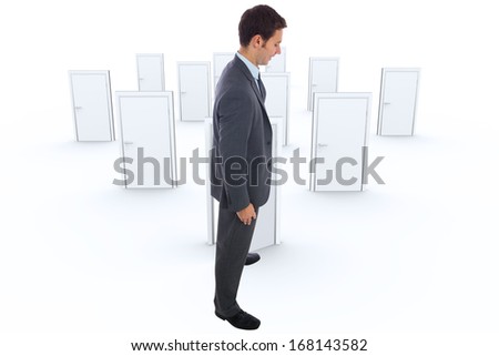Cheerful businessman standing with hands on hips against many doors closed shut with one opening