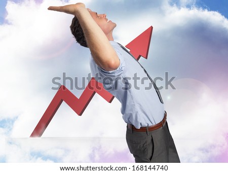Businessman standing with hands up against red jagged arrow pointing up against sky