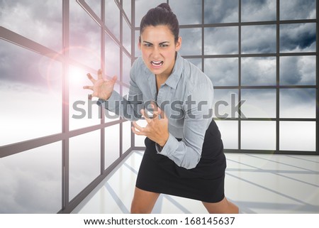 Furious businesswoman gesturing against gloomy sky seen through windows