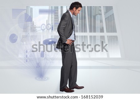 Smiling businessman with hands on hips against steps leading to light in the darkness