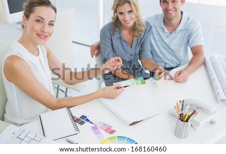 Group of artists working on designs in a bright office