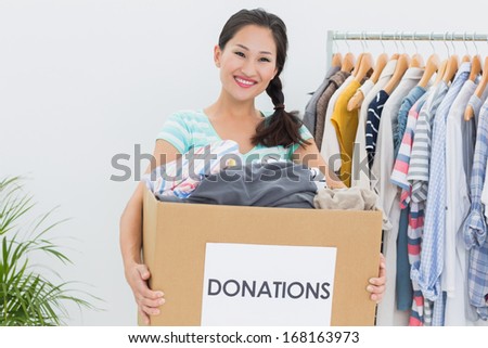 Portrait of a young woman with clothes donation