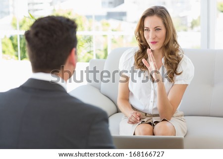 Smiling young woman in meeting with a financial adviser at home