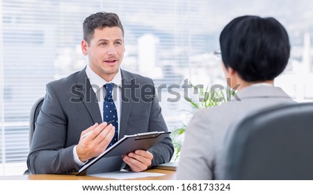 Male recruiter checking the candidate during a job interview at office