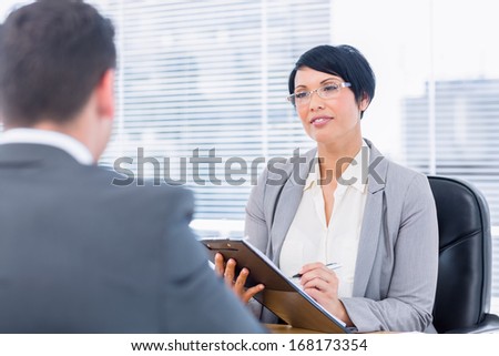 Female recruiter checking the candidate during a job interview at office