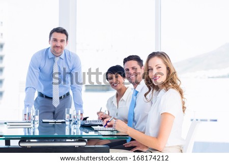 Smartly dressed young executives around conference table in office