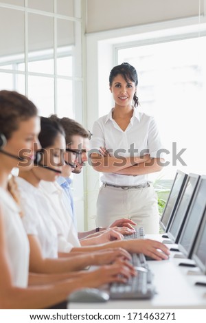 Portrait of female manager with business staff working in a call center
