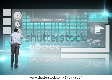 Businessman with hand on hip against computer applications