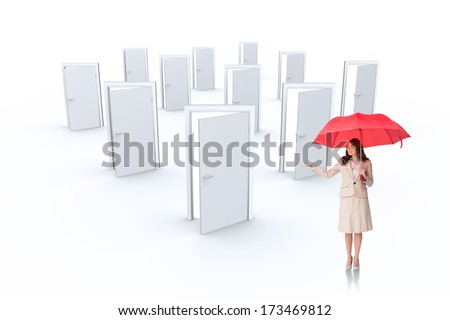 Attractive businesswoman holding red umbrella against many doors opening