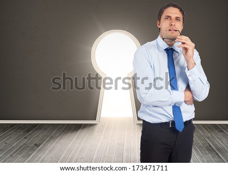 Thinking businessman biting glasses against steps leading to open door showing light