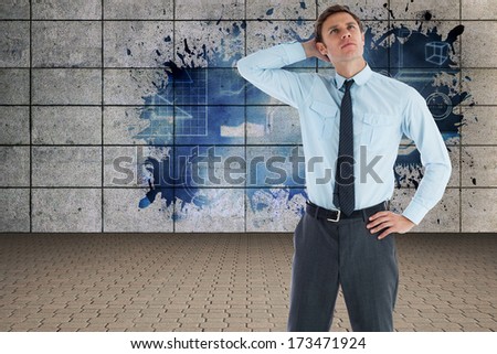 Thoughtful businessman with hand on head against grey room with dollar door