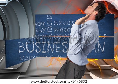 Businessman standing with arms pushing up against orange energy design on a futuristic structure