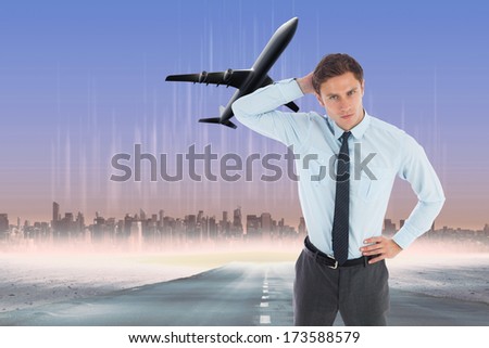 Thinking businessman scratching head against cityscape on the horizon