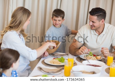 Happy family eating lunch at dining table in house