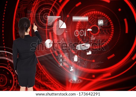 Businesswoman pointing against shiny red circles on black background