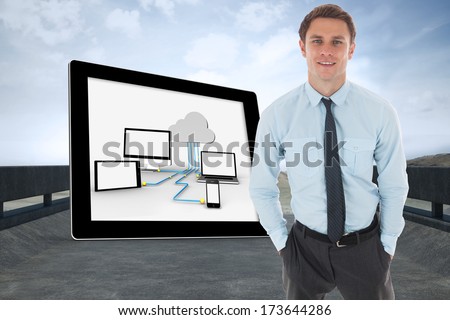 Happy businessman standing with hands in pockets against road leading out to the horizon