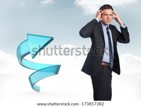 Stressed businessman with hands on head against blue spiral arrow in the sky