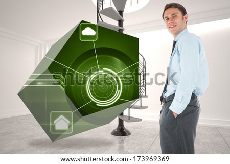 Happy businessman standing with hand in pocket against digitally generated room with winding staircase
