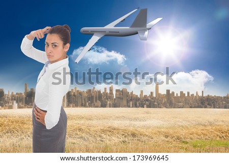 Focused businesswoman against large city on the horizon