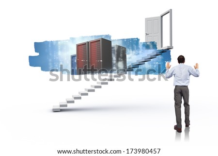 Businessman posing with hands up against abstract screen in room showing server towers
