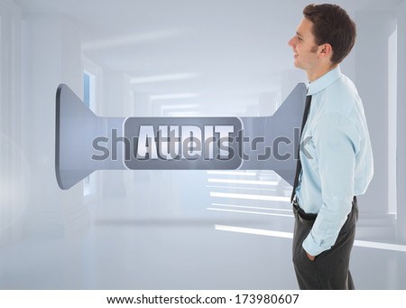 Happy businessman standing with hand in pocket against bright white hall with columns