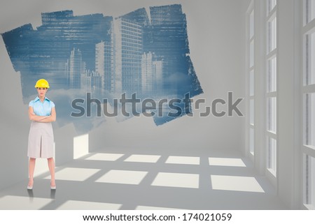 Serious pretty architect posing against abstract screen in room showing technology interface