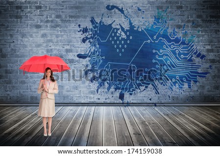 Attractive businesswoman holding red umbrella against splash showing circuit board