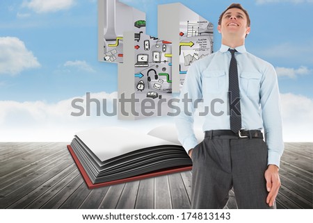 Happy businessman standing with hand in pocket against open book against sky