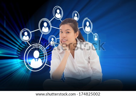 Businesswoman sitting cross legged thinking against digital earth background
