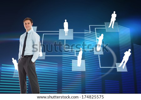 Smiling businessman standing with hands in pockets against glowing blue bar chart on black background