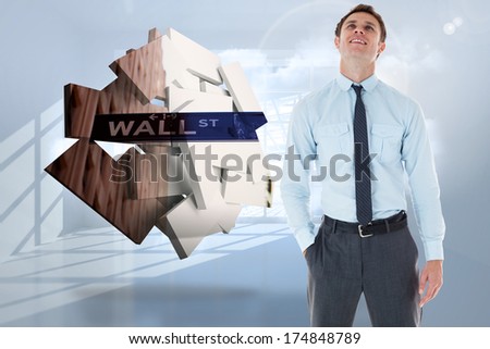 Smiling businessman standing with hand in pocket against room with holographic cloud