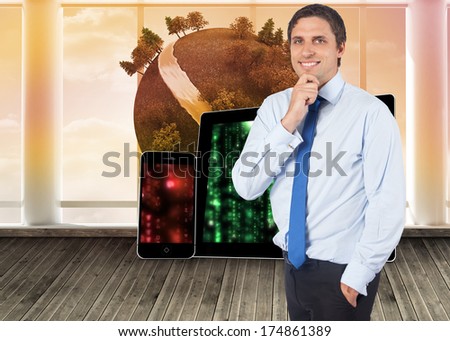 Thinking businessman touching his chin against digital earth floating in room