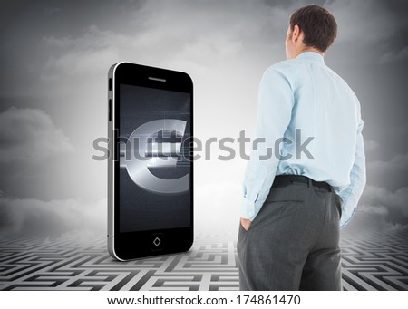 Businessman standing with hands in pockets against maze ending in cloudy sky