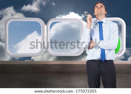Thinking businessman holding pen against balcony and cloudy sky