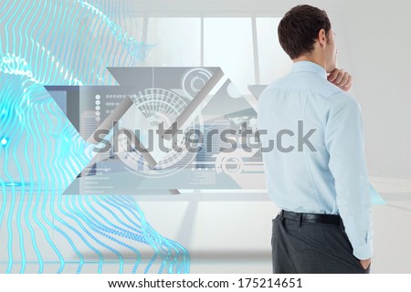 Thoughtful businessman with hand on chin against abstract blue design in white room