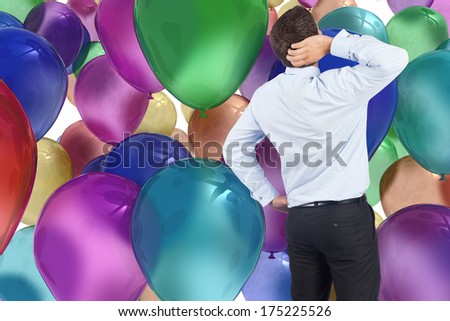 Thinking businessman scratching head against colourful balloons