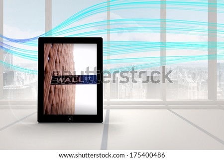 Wall street on tablet screen against abstract blue line design in room