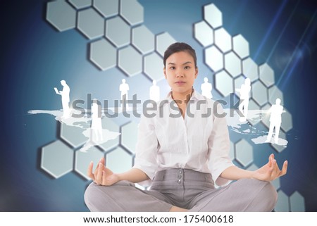 Businesswoman sitting in lotus pose against technological background with hexagons