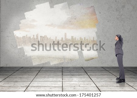 Thinking businessman scratching head against display on wall showing cityscape