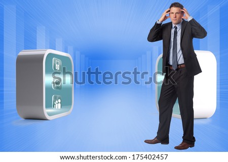 Stressed businessman with hands on head against bright blue room