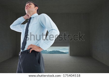 Thinking businessman with hand on head against door opening in dark room