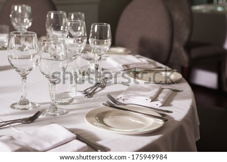 Set table with white linen in a fancy restaurant