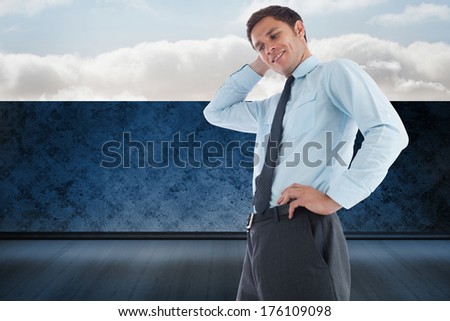 Thinking businessman with hand on head against balcony and bright sky