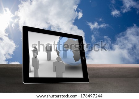 Figures and earth on tablet screen against balcony and cloudy sky