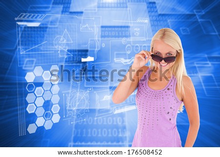 Charming woman peeking over her sunglasses against shiny background with squares